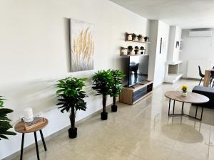 a living room with potted plants on the wall at Gtrip Nea Smyrni Floor Apartment 7F in Athens