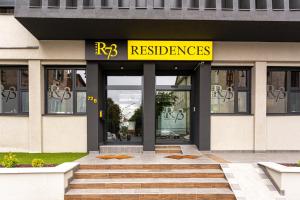 a restaurant with a yellow sign on the front of a building at R73 Residences in Pécs