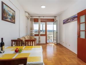 a living room with a table with fruit on it at Tivat Center SeaView Apartment in Tivat