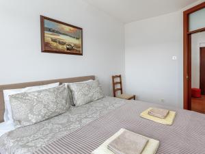 a bedroom with a bed and a picture on the wall at Tivat Center SeaView Apartment in Tivat