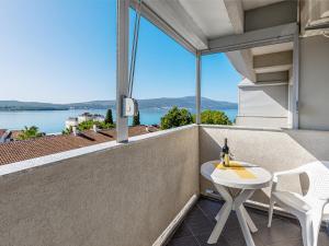 a balcony with a table and chairs and a view of the water at Tivat Center SeaView Apartment in Tivat