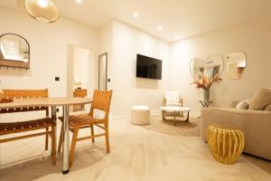 a living room with a table and a couch at NEW Luxury & Cozy Apartment - 6p in Paris