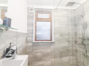 a bathroom with a shower and a sink at Ruskin Lodge in Windermere +27 photos