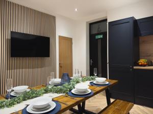 a dining room with a table with plates and bowls at Station House Haworth in Haworth