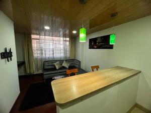 a living room with a table and a couch at Welcome to Bogota 2 in Bogotá