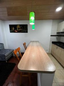 a wooden table in a kitchen with a couch at Welcome to Bogota 2 in Bogotá