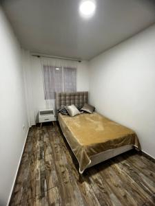 a bedroom with a bed and a wooden floor at Welcome to Bogota 2 in Bogotá