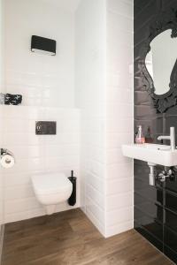 een badkamer met een wit toilet en een wastafel bij Molepôlle 7 - Stadslogementen Franeker in Franeker