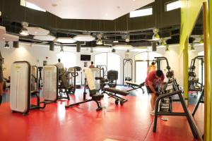 a gym with several tread machines and people in it at Shams JBR Hostel in Dubai