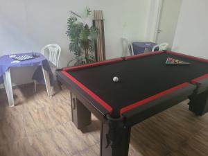 a pool table with a ball on top of it at Hotel Novo Horizonte - By UP Hotel in Monte Sião