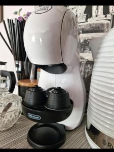 a white blender sitting on top of a table at CozyPlace in Kuldīga