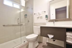 a bathroom with a toilet and a sink and a shower at Hotel 414 Anaheim in Anaheim