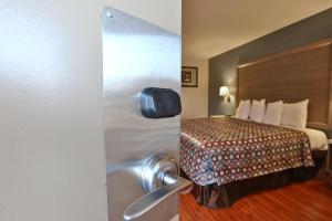 a door to a hotel room with a bed at Hotel 414 Anaheim in Anaheim