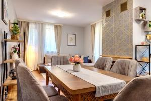a living room with a table and chairs at Luxury Flat in Grand Resort Pamporovo in Pamporovo