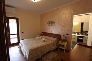 a bedroom with a bed and a table and a window at Casa Nicole in Manerba del Garda