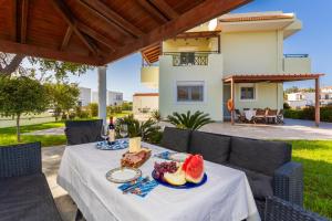 a table with a plate of food on it at Amphitrite Villa in Gennadi