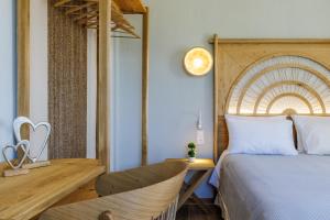 a bedroom with a bed and a desk and a clock at Villa Nektaria in Alikias