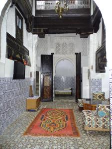 a living room with an archway and a rug on the floor at Riad Amimi Fes in Fez