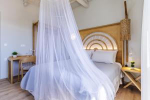 a bedroom with a bed with a mosquito net at Villa Nektaria in Alikias