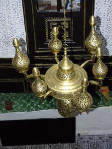 a group of gold vases hanging from a chandelier at Riad Amimi Fes in Fez
