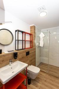 a bathroom with a sink and a toilet and a shower at R73 Residences in Pécs