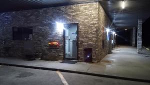 a brick building with a door with lights on it at Coachman's Inn & Suites in Waldron +34 photos
