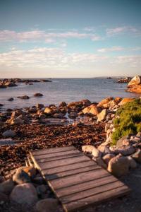 a wooden walkway on a rocky beach near the water at Sea Shack in Paternoster