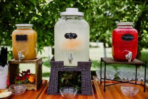 three glass jars sitting on top of a table at Stupina in Braşov