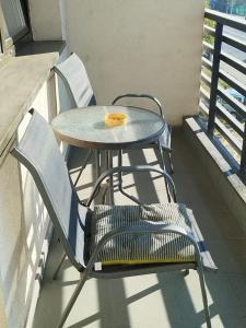 a table and chairs sitting on a balcony at River Lux in Bacău