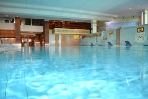 a swimming pool with blue water in a building at fewo-sporer in Sankt Englmar