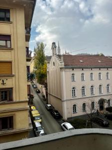 a view of a city street with cars parked at A96 in Budapest