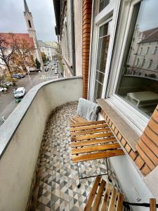 a bench on a balcony with a view of a street at A96 in Budapest