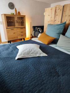 a bedroom with a large blue bed with two pillows at Ferienhaus Sinneswandel in Sehmatal