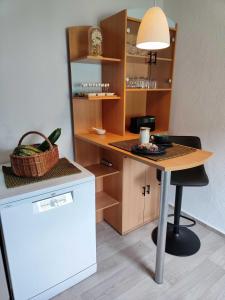 a kitchen with a table with a lamp on it at Ferienhaus Sinneswandel in Sehmatal +23 photos