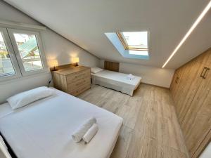 Schlafzimmer im Dachgeschoss mit 2 Betten und einem Dachfenster in der Unterkunft Trendy Loft Apartment in Limassol