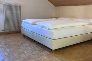 two twin beds in a room with at Appartamenti Ladina in Campitello di Fassa