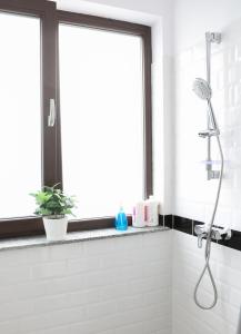 a white bathroom with a shower and a window at Vitan Central Oasis - NEW Building - FREE Secured Private PARKING - Self Check-in - in Bucharest