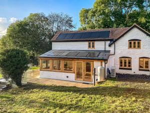 a house with solar panels on the roof at Quabbs Head Cottage in Mathon