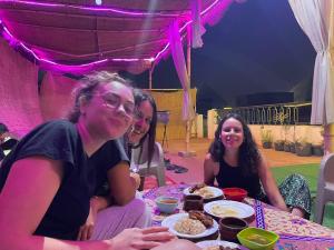 a group of women sitting at a table with food at Jana Pyramids view inn in Cairo