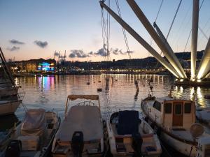 eine Gruppe von Booten, die in einem Hafen mit einer Brücke angedockt sind in der Unterkunft Porto Antico Exclusive Apartment in Genua