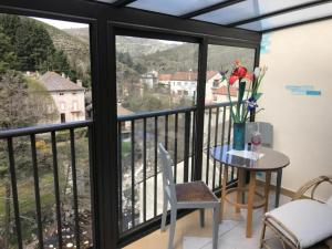 a balcony with a table and a view at Le Grenier d'annick in Villefort