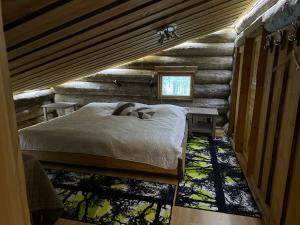 a bedroom with a bed in a log cabin at Casa Levi Luxury Chalet in Levi
