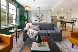 a living room with a couch and a table at Timeless Elegance: 4BR Luxury Condo in New Orleans in New Orleans