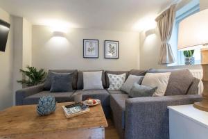 a living room with a couch and a table at Cosy & Peaceful Self Contained Home in Montpellier in Cheltenham
