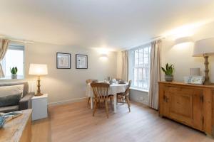 a living room with a table and chairs and a couch at Cosy & Peaceful Self Contained Home in Montpellier in Cheltenham