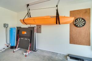 a kayak hanging from a wall in a garage at Gorgeous Harrison Getaway with Patio and Kayak! in Harrison
