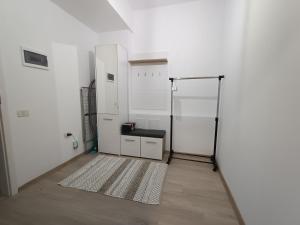 a room with white walls and a rug at Studio Modern Class in Bucharest