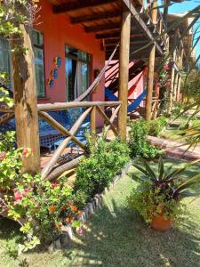 a house with a wooden fence and some plants at Chaleville Coqueiro 1001 in Luis Correia