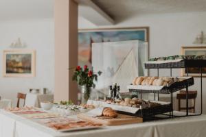 - une table avec différents types de pain et de viennoiseries dans l'établissement Hotel Bellavista, à Grado