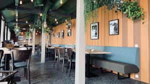 two views of a restaurant with tables and chairs at HOTEL ALPINA EINHORN - Self-Check-In in Wolfenschiessen +69 photos